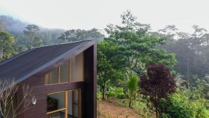 a house in the middle of a forest at Galactic Glow Villa & Resort in Deniyaya