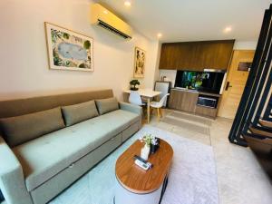 a living room with a couch and a table at Utopia Loft in Rawai Beach