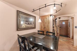 a dining room with a black table and chairs at Telemark Lodge #504 in Copper Mountain