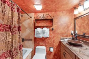 a bathroom with a toilet and a sink and a tub at Telemark Lodge #504 in Copper Mountain +10 photos