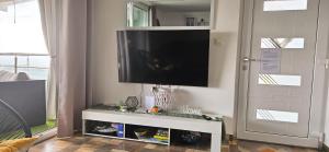 a flat screen tv on a wall next to a door at Elis in Hrašćina
