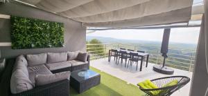 a living room with a couch and a table on a balcony at Elis in Hrašćina