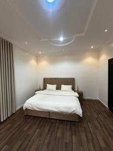 a bedroom with a large bed with white sheets at غرف خاصة مودرن in Hail
