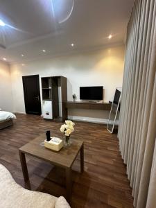 a living room with a couch and a table at غرف خاصة مودرن in Hail