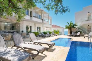 an image of a villa with a swimming pool at Synthea Suites in Chrysi Ammoudia