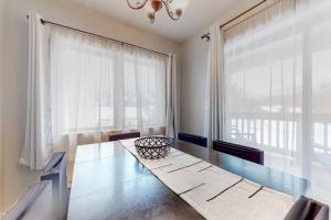 a dining room with a table and a large window at Mountain Village #5H in Dover