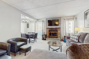 a living room with a couch and a fireplace at Mountain Village 5H Unit A in Dover
