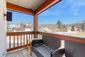 a balcony with a table and chairs and a view at Mountain Village 5H Unit A in Dover