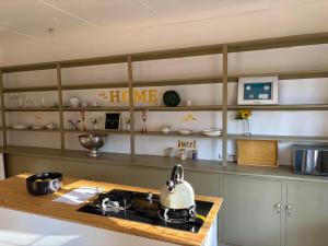a kitchen with a tea kettle on a stove at Garden Cottage - Self Catering in Amanzimtoti