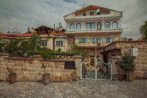 a large building with a gate in front of it at Gazel Cave House in Ürgüp