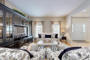 a living room with two couches and a tv at Vermont Ski House in Vermont Ventures