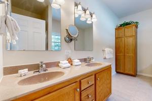 a bathroom with two sinks and a large mirror at Vermont Ski House in Vermont Ventures +42 photos