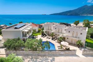 an aerial view of a house with a swimming pool at Synthea Suites in Chrysi Ammoudia