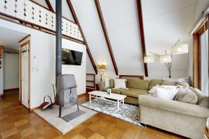 a living room with a couch and a fireplace at A-Frame Escape in Ludlow