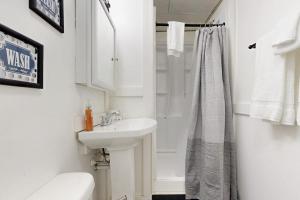 a white bathroom with a sink and a shower at A-Frame Escape in Ludlow +59 photos