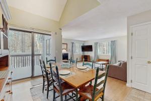 a dining room with a table and chairs at Newton Village 2B in Quechee