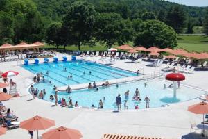 a group of people in a pool at a resort at Newton Village 2B in Quechee