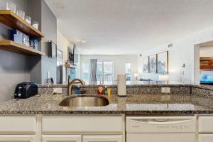 a kitchen with a sink and a counter top at Okemo Mountain Lodge A208 in Ludlow +35 photos