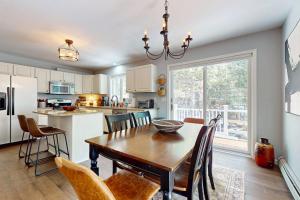 a kitchen and dining room with a table and chairs at Kindred Hollow in Ludlow