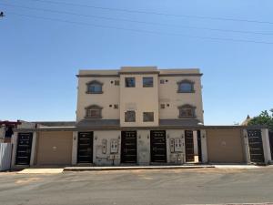 a large white building with a lot of garage doors at غرف خاصة مودرن in Hail