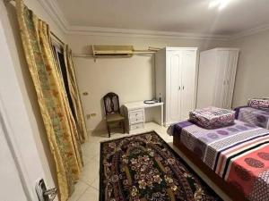 a bedroom with two beds and a desk and a chair at Amr home in Amman
