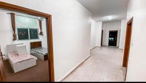 a room with a mirror and a room with a couch at Amr home in Amman