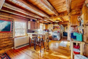 a large kitchen with wooden walls and wooden floors at The Cabin at Fort Defiance in Barnard