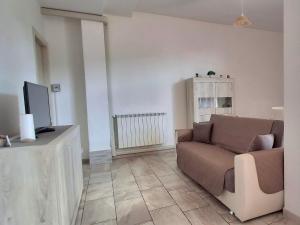 a living room with a couch and a tv at La Casa di Anastasya in Castiglione Torinese