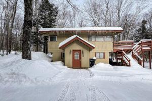 a house with a red door in the snow at The Last Run in Wardsboro
