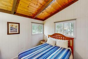 a bedroom with a bed with a wooden ceiling at The Last Run in Wardsboro