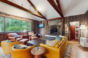 a living room with yellow furniture and a fireplace at Lincoln Gap Retreat in Warren