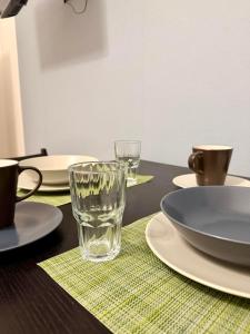 a table with a glass of water on a table at Lauro Apartment in Meta +7 photos