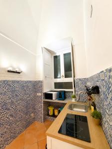 a kitchen with a sink and a counter top at Lauro Apartment in Meta