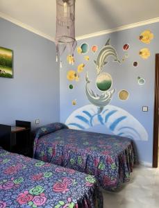 a bedroom with two beds and planets and a wall at Casa Bartolo in Vélez-Rubio