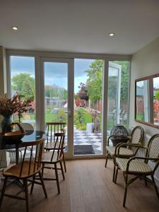 a living room with a table and chairs and a patio at Margate beach house in Margate