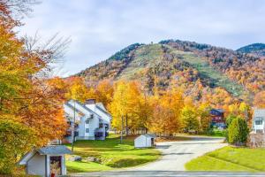 a house on a road in front of a mountain at Sunrise - East Glade-C7 in Killington