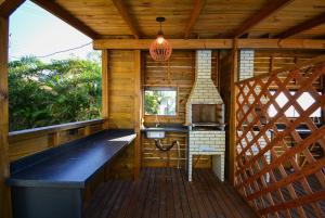 an outside view of a kitchen in a wooden cabin at Chalé com Jacuzzi e Vista Mar - PLH007 in Palhoça