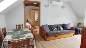 a living room with a couch and a table at Katica Vendégház in Siófok