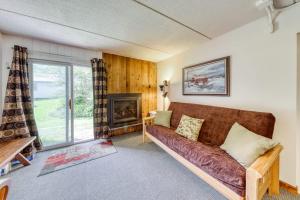 a living room with a couch and a fireplace at Cozy Mountainside Condo in Waitsfield +42 photos