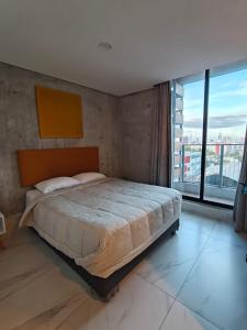 a bedroom with a large bed and a large window at Purísima 5 0 in Monterrey