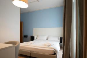 a bedroom with a bed with two towels on it at Hotel Minerva in Caorle