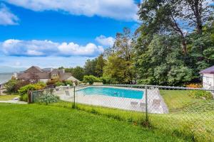 a fence around a swimming pool in a yard at Mountainside 75 in Warren