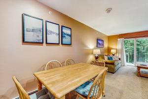 a dining room with a wooden table and chairs at Mountainside 75 in Warren