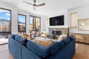 a living room with a blue couch and a fireplace at Summit Blue #30 : 2 in Silverthorne +38 photos
