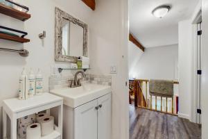 a white bathroom with a sink and a mirror at Quechee Hollow 1F in Quechee +26 photos