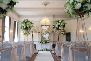 a room filled with tables and chairs with flowers at Hotel Rudyard in Leek