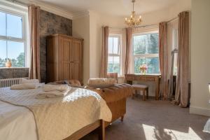 a bedroom with two beds and two windows at Hotel Rudyard in Leek +47 photos
