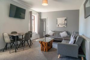 a living room with a couch and a table at Hotel Rudyard in Leek