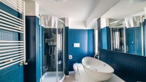 a bathroom with a toilet and a glass shower at Casa Superga by Rentbeat in Cisternino +12 photos