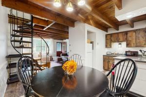 a kitchen and dining room with a table and chairs at Quechee Hollow 2C in Quechee